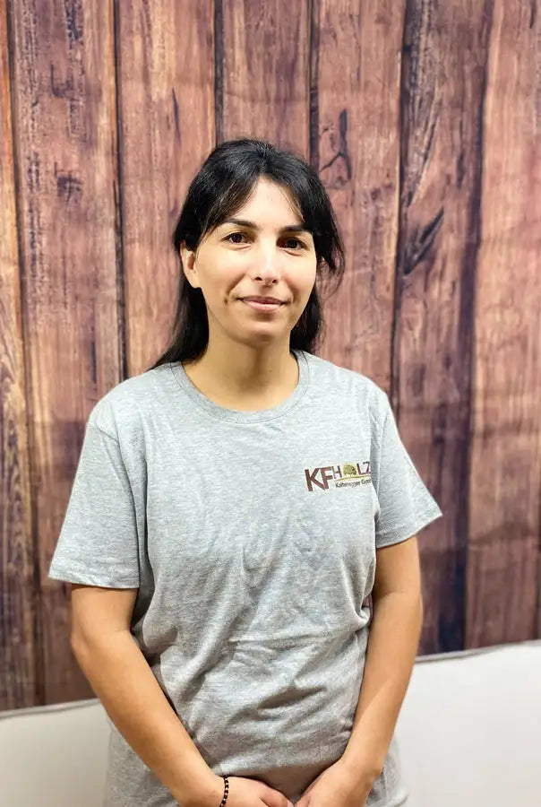 Graues kurzärmeliges T-Shirt mit einem kleinen gestickten Logo auf der linken Brust.